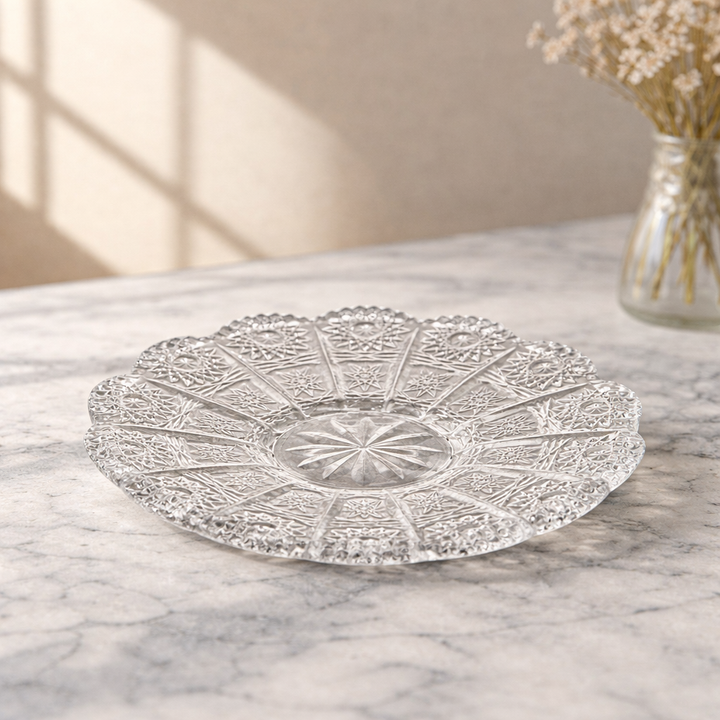 Vintage-inspired clear glass cup and saucer photographed on a light background
