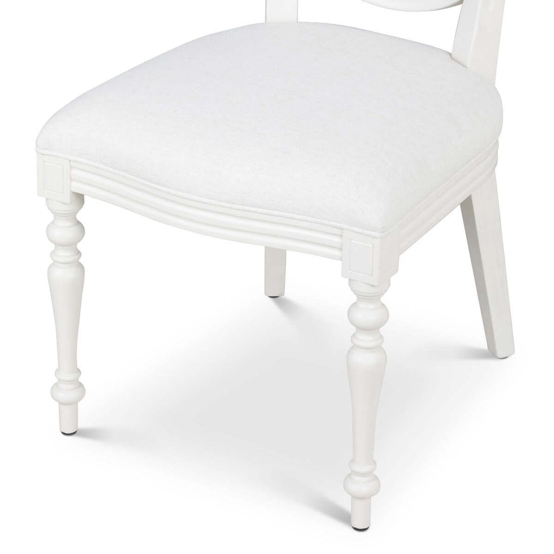 Vintage Farmhouse Cane Back Dining Chair with linen upholstery and hand-carved wood legs.