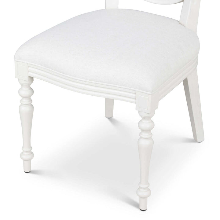 Vintage Farmhouse Cane Back Dining Chair with linen upholstery and hand-carved wood legs.