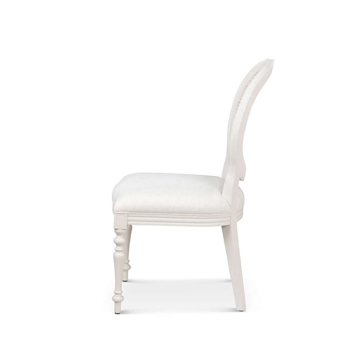Side view of Vintage Farmhouse Cane Back Dining Chair with linen upholstery and hand-carved wood legs, inspired by European simplicity.