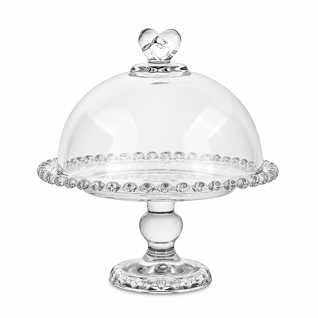 Vintage glass cake stand with cloche styled with delicate pink desserts