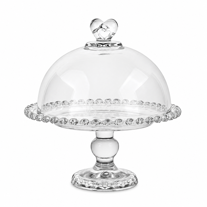 Vintage glass cake stand with cloche styled with delicate pink desserts