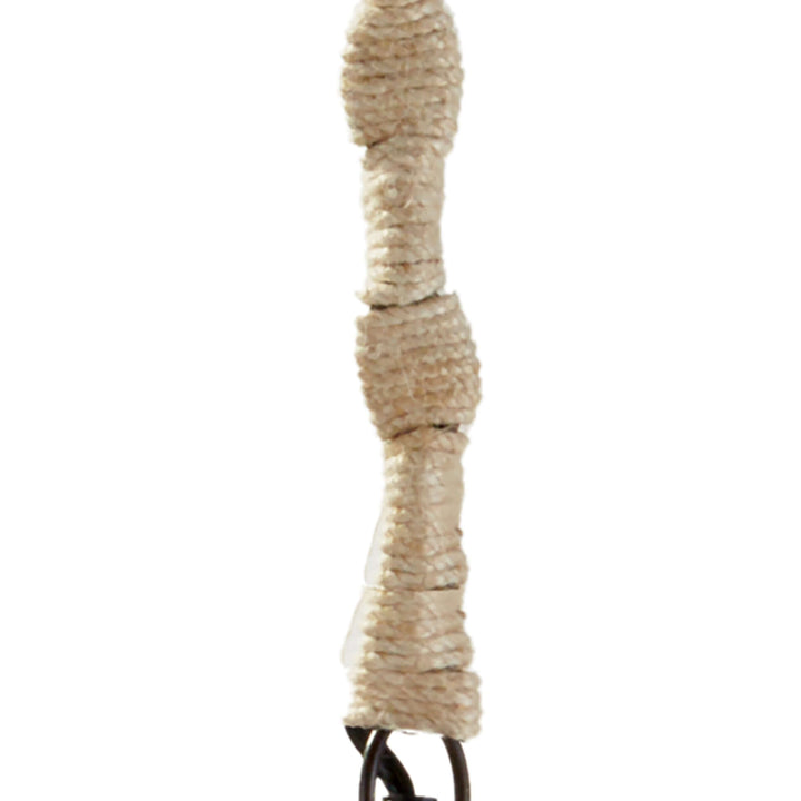 Close-up of a vintage pendant light's textured cord with rustic wood accents, enhancing its charming design.