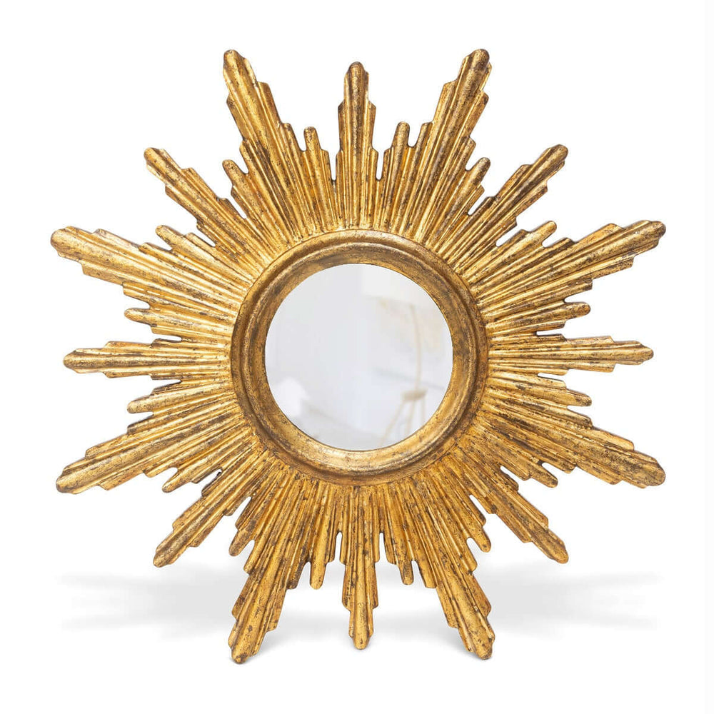 Vintage gold sunburst wall mirror with textured rays and mid-century design.