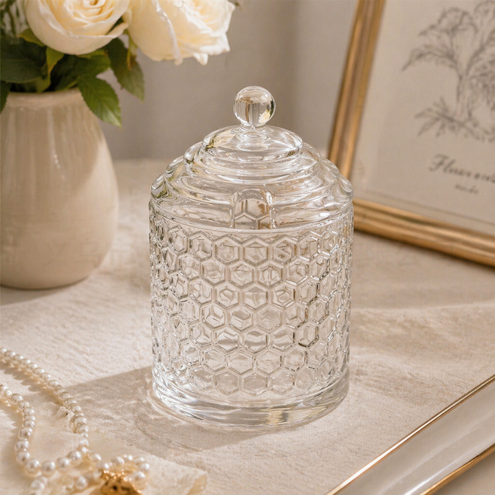 Vintage honeycomb glass storage jar with lid styled on a pearl-draped table
