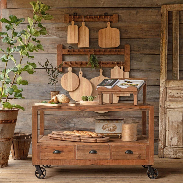 Vintage Industrial Factory Cart Island with reclaimed wood and black metal wheels in rustic kitchen setting.