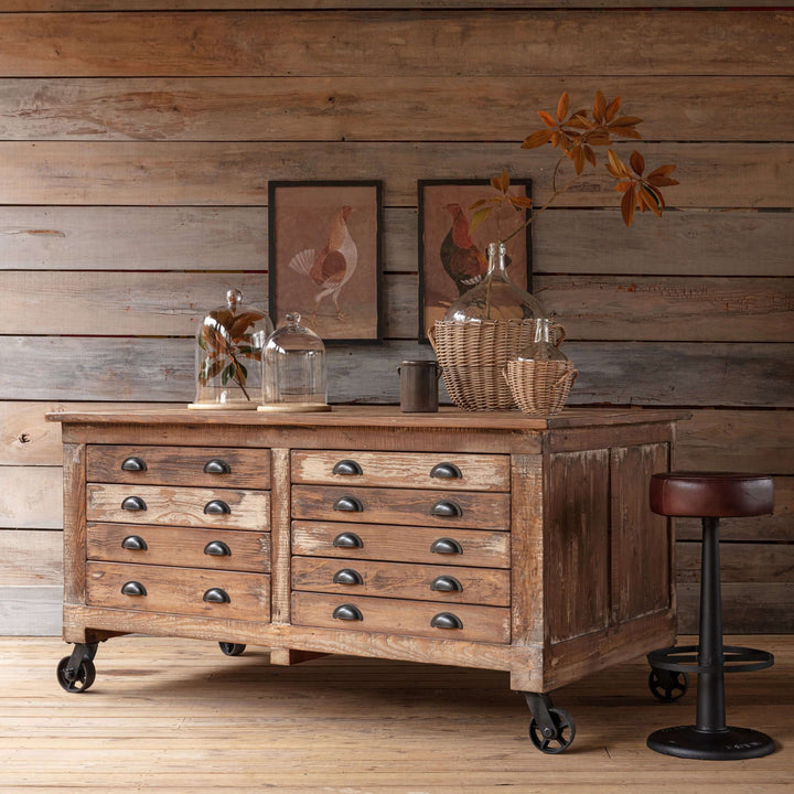 Vintage Industrial Rolling Workbench with Drawers made from reclaimed wood in rustic setting