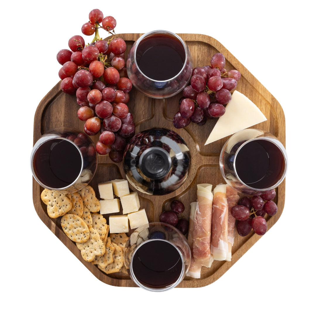 Vintage-Inspired Wine Picnic Table with wine glasses, cheese, crackers, grapes, and meats on a wooden surface.