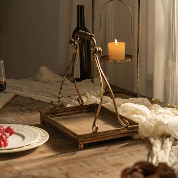 Antique gold metal serving tray on a rustic table with candlelight, evoking vintage elegance and old-world charm.