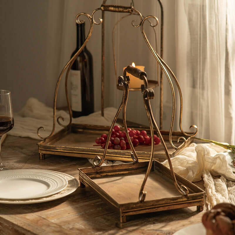 Vintage-inspired antique gold metal serving trays with ornate scrollwork handles, perfect for elegant dining.