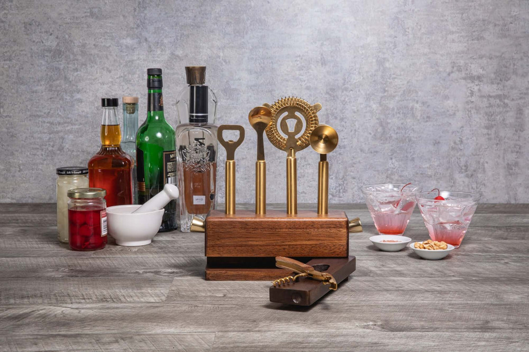 Vintage-Inspired Bar Tool Set with Brass Finish on display with assorted liquors and cocktails