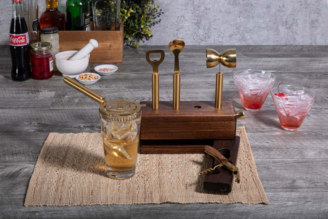 Vintage-Inspired Bar Tool Set with Brass Finish on display with cocktail accessories on a wooden counter.