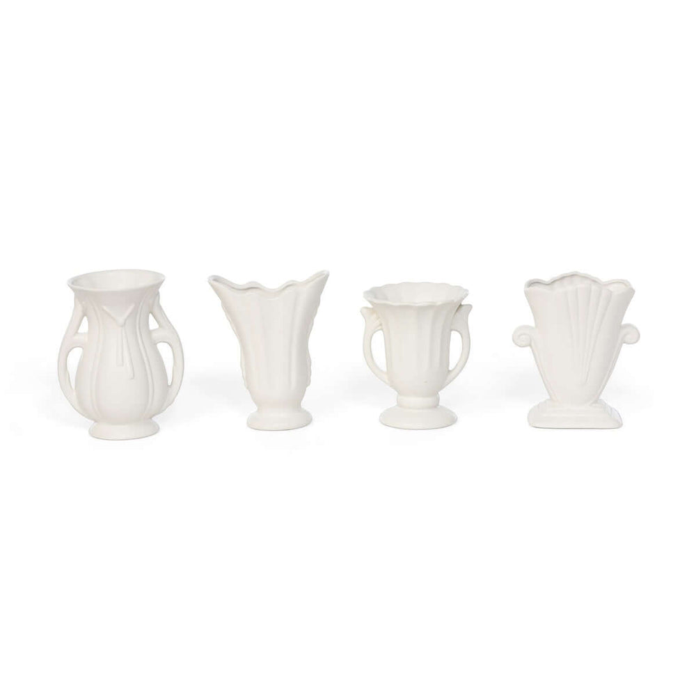 Set of 4 vintage-inspired white ceramic vases with elegant curves and matte finish, perfect for home decor elegance.