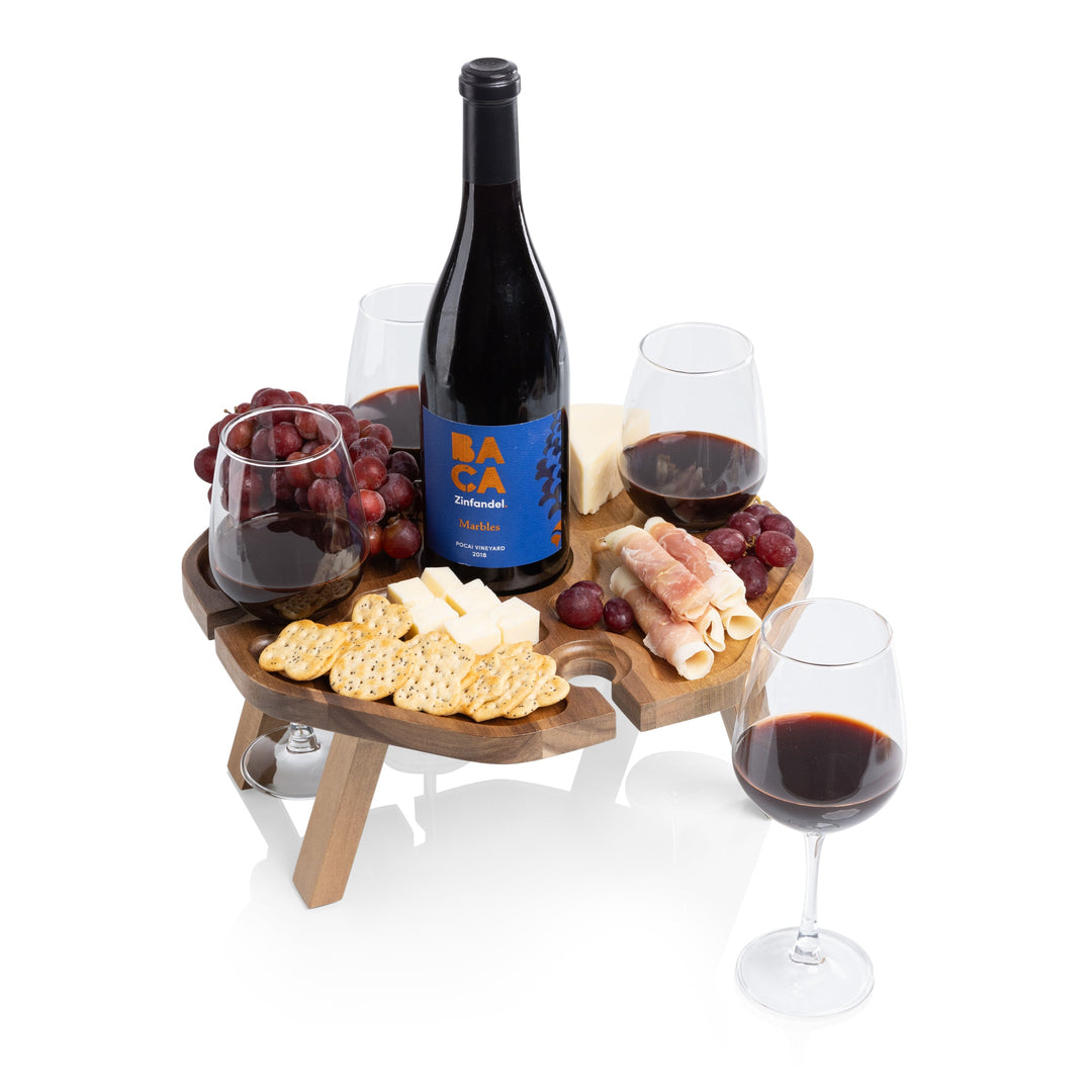 Vintage-Inspired Wine Picnic Table with wine, cheese, and glasses on acacia wood with folding legs for outdoor entertaining.