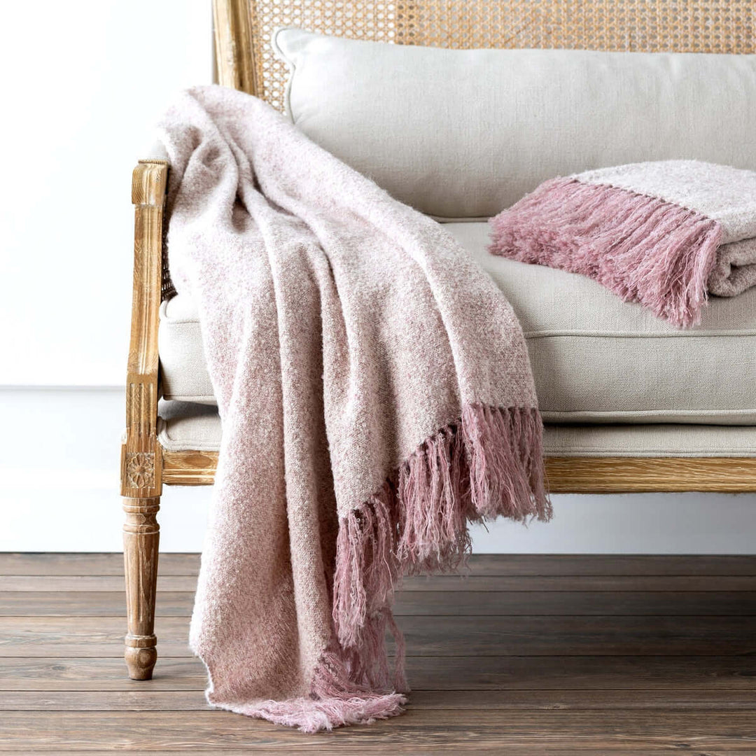 Vintage Light Blush Boucle Alpaca Wool Throw Blanket on elegant chair, evoking French countryside style with handmade craftsmanship.