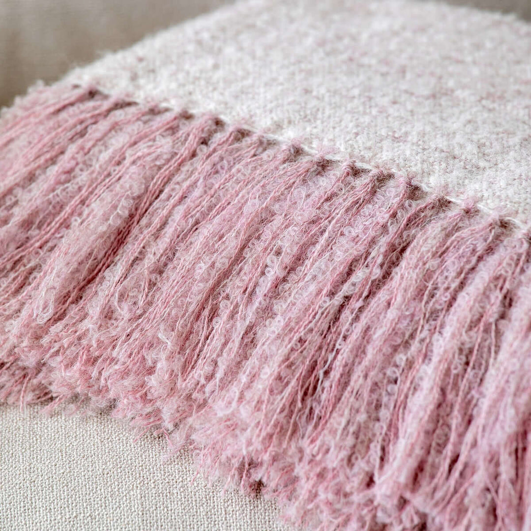 Vintage Light Blush Boucle Alpaca Wool Throw Blanket with fringe detail, showcasing soft texture and elegant design, handwoven by artisans.
