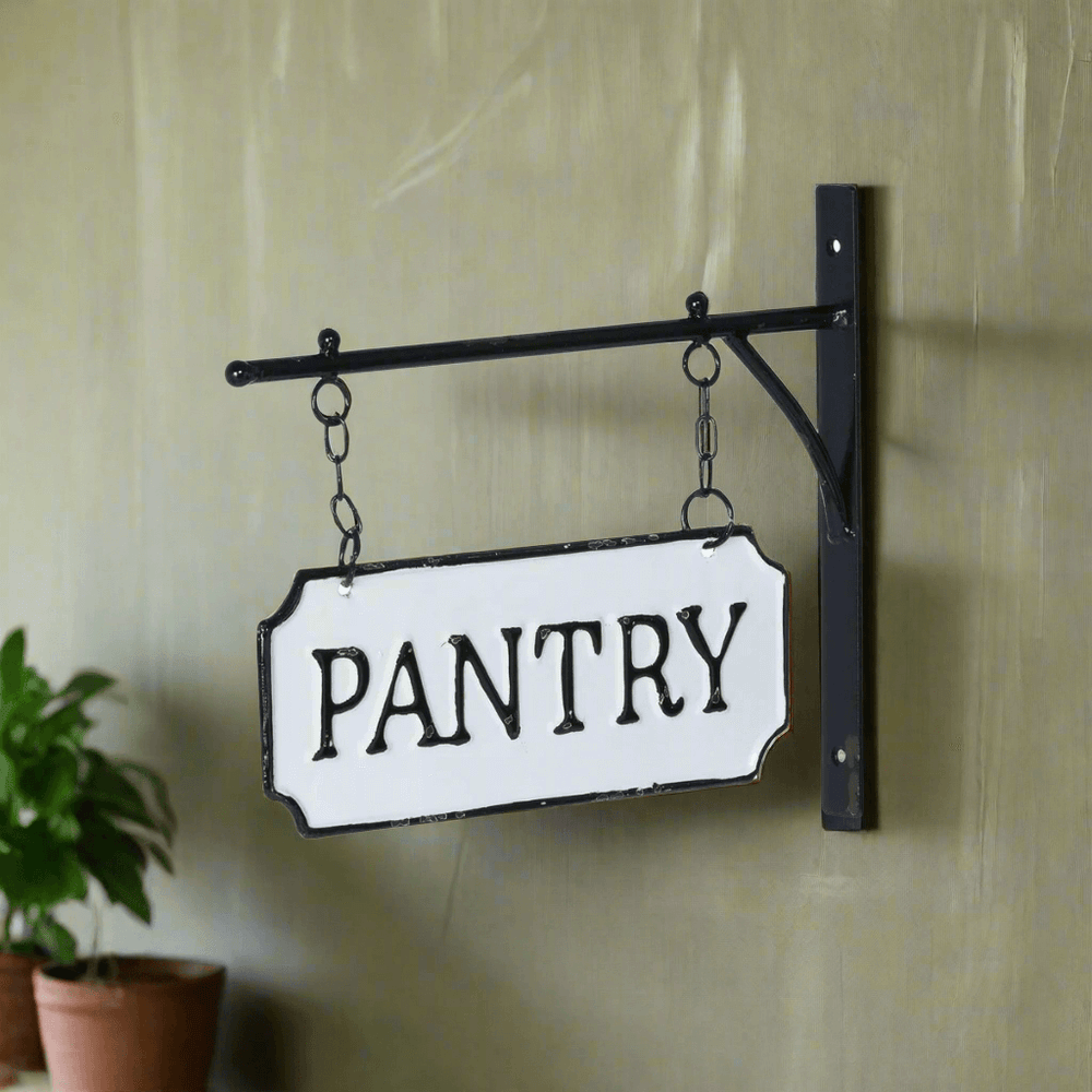 Vintage metal pantry sign with hanging display bar, featuring black-and-white enamel-style design, evoking old country kitchen charm.