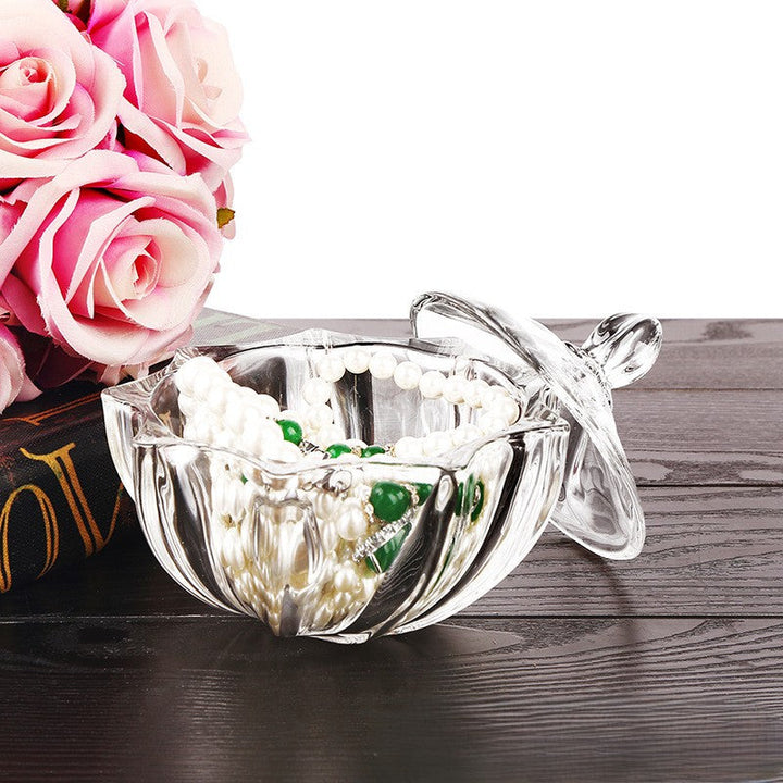 Close detail of the faceted lid and scalloped petal-shaped glass body