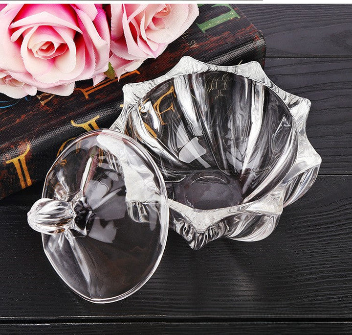 Decorative cut-glass jar with floral silhouette and jewel-like lid