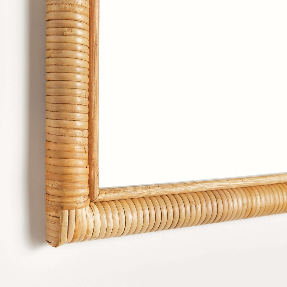 Close-up of vintage rattan framed wall mirror showcasing its hand-wrapped texture and elegant design for coastal homes.