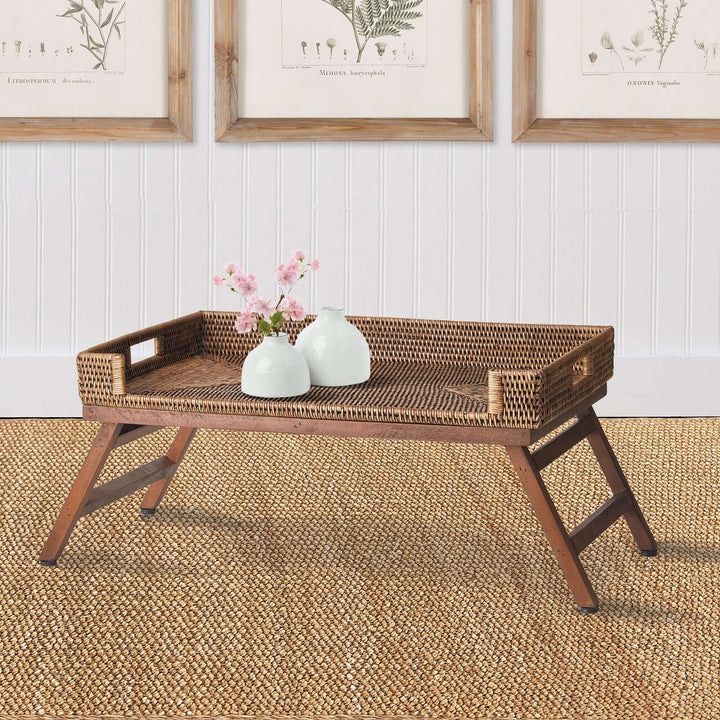 Vintage rattan tray table with collapsible legs, featuring elegant design and natural charm, perfect for home decor.