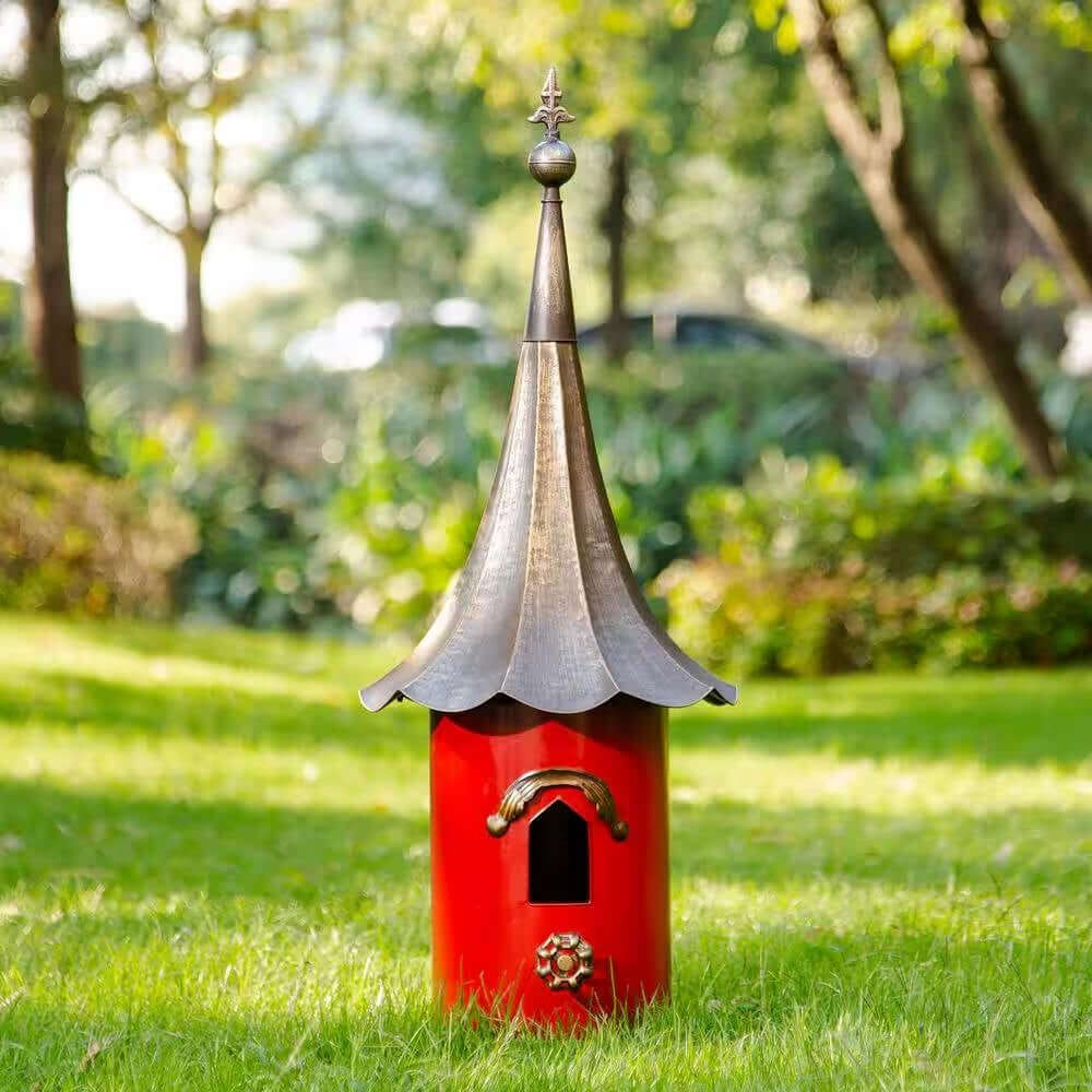 Vintage Red Metal Birdhouse with Bronze Pagoda Roof in a garden setting