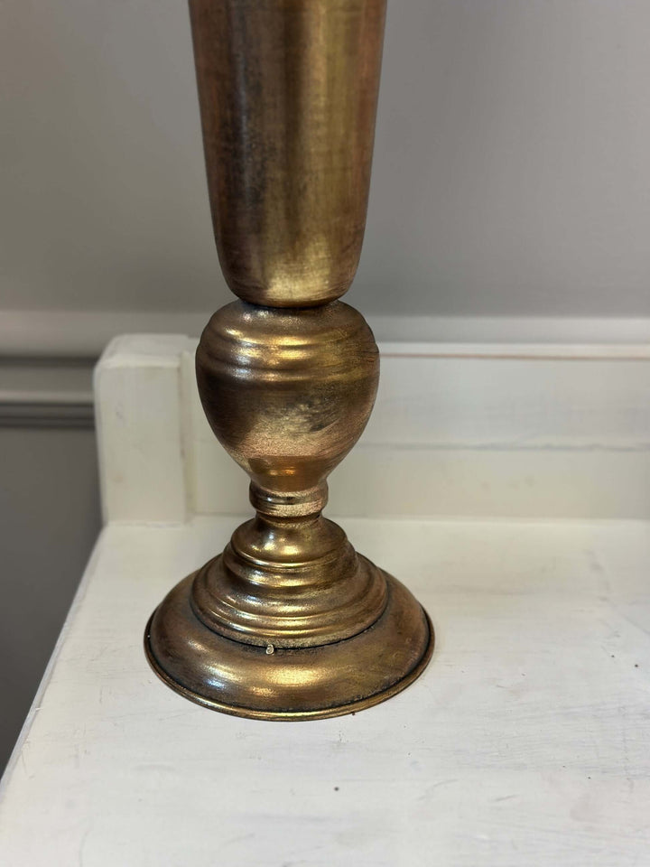 Detail of vintage tall gold trumpet vase with antique finish, perfect for elegant floral arrangements and adding sophistication to decor.