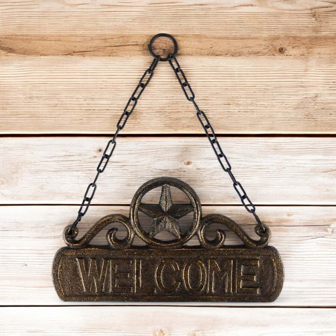 Vintage Western Cast Iron Welcome Sign with Chain on wooden background, featuring star design and rustic finish.