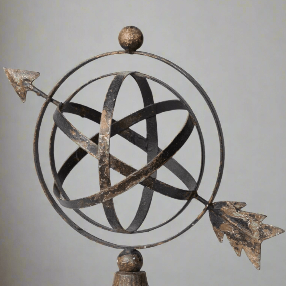 Vintage Armillary Iron Sculpture with Arrow, decorative iron bands and arrow design, inspired by ancient astronomical tools.