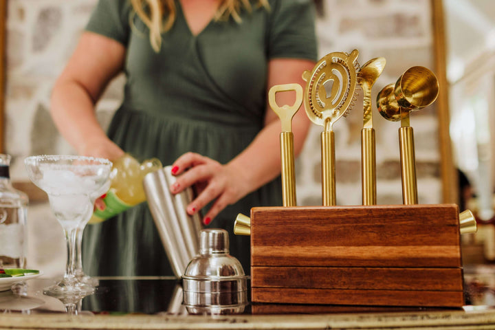 Vintage-Inspired Bar Tool Set with Brass Finish displayed on bar counter.