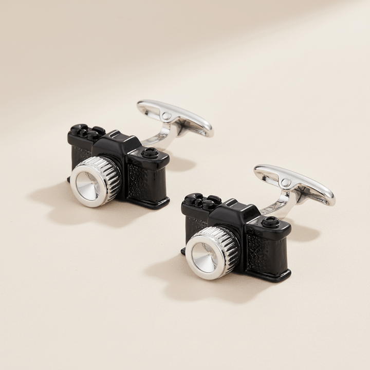 Vintage Black Camera Cufflinks inspired by the golden age of photography on a beige background, elegant accessory for photography enthusiasts.