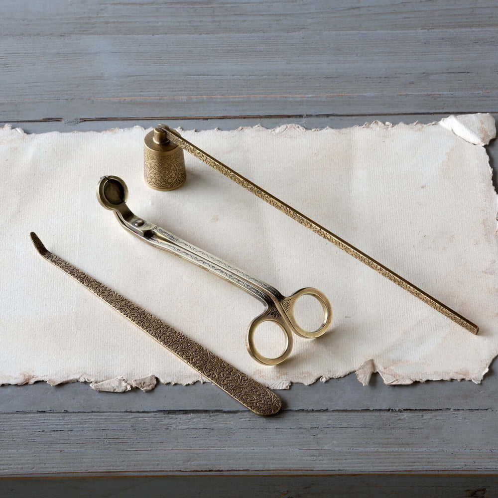 Vintage Brass Candle Care Kit Set of 3 with trimmer, snuffer, and wick dipper on a rustic surface
