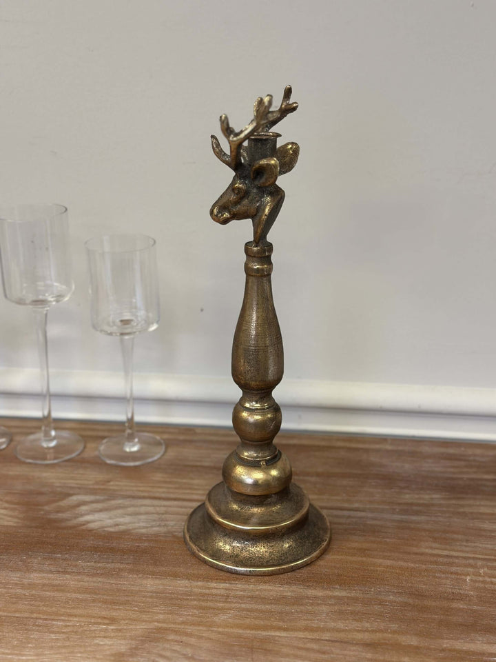 Vintage brass deer head candle holder with sculpted antlers on wooden base, adds rustic charm to home decor.