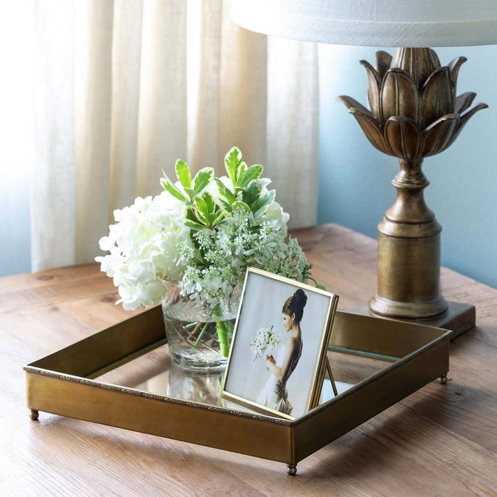 Elegant Vintage Brass and Glass Desk Tray on wooden table with decorative items, including a flower vase and photo frame.