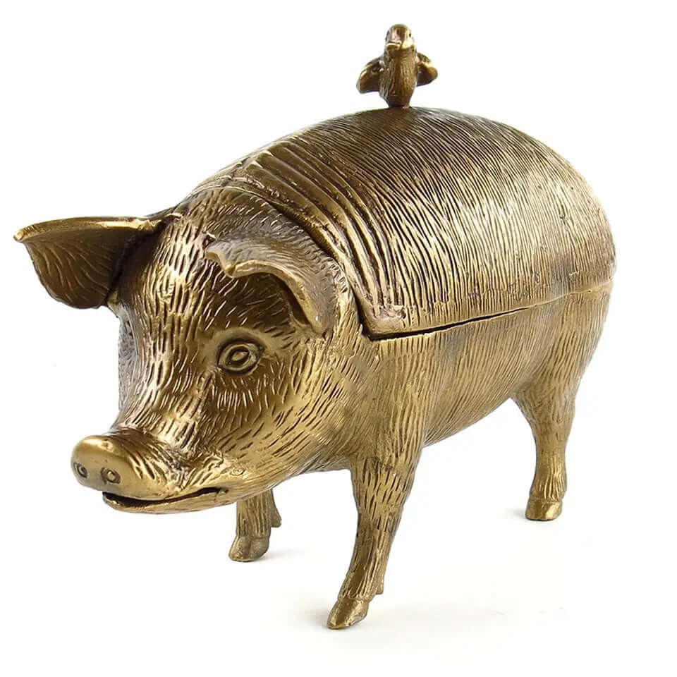 Vintage brass pig-shaped storage box with textured surface and lifelike detailing, inspired by rustic farmhouse kitchens.