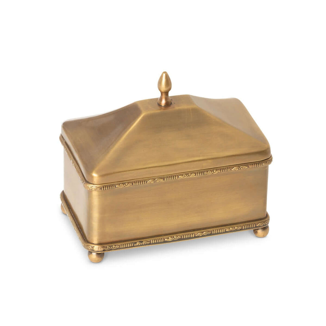 Vintage brass trinket box with lid and decorative edging, rectangle shape, sitting on ball feet, evoking old-world elegance.