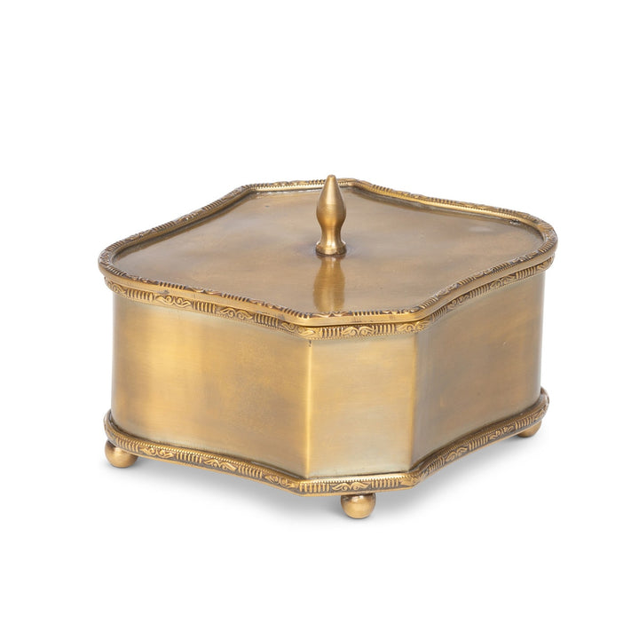 Vintage brass trinket box with lid, hexagonal shape, decorative edging, and ball feet, ideal for jewelry storage.