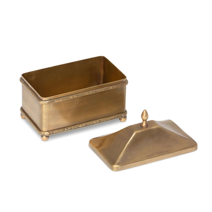 Rectangular vintage brass trinket box with lid, featuring decorative edging and ball feet, ideal for jewelry or small keepsakes.