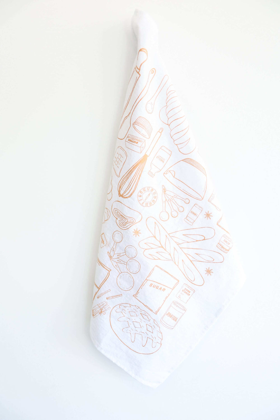Vintage Bread Baking Tea Towel with hand-drawn baking illustrations hanging against a white background