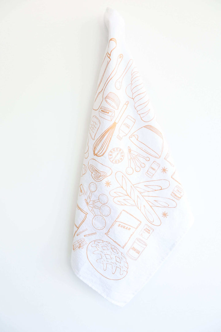 Vintage Bread Baking Tea Towel with hand-drawn baking illustrations hanging against a white background