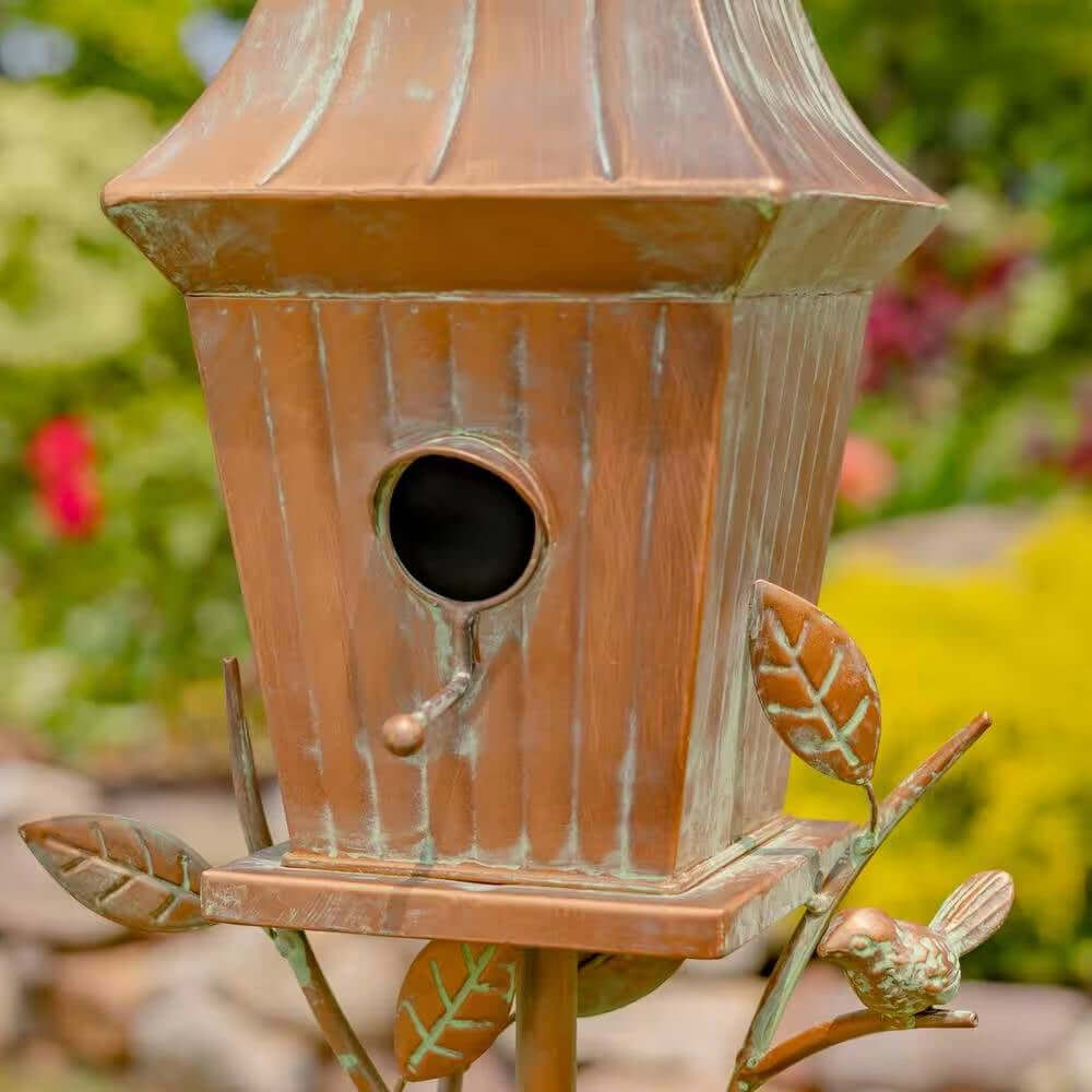 Vintage Copper Finish Garden Birdhouse with Stake in a garden setting.