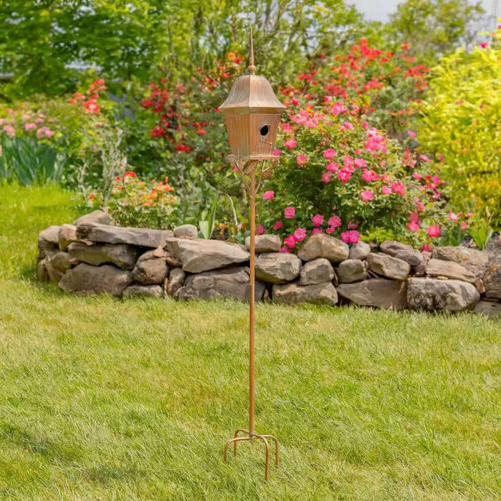 Vintage Copper Finish Garden Birdhouse with Stake in a blooming garden setting.
