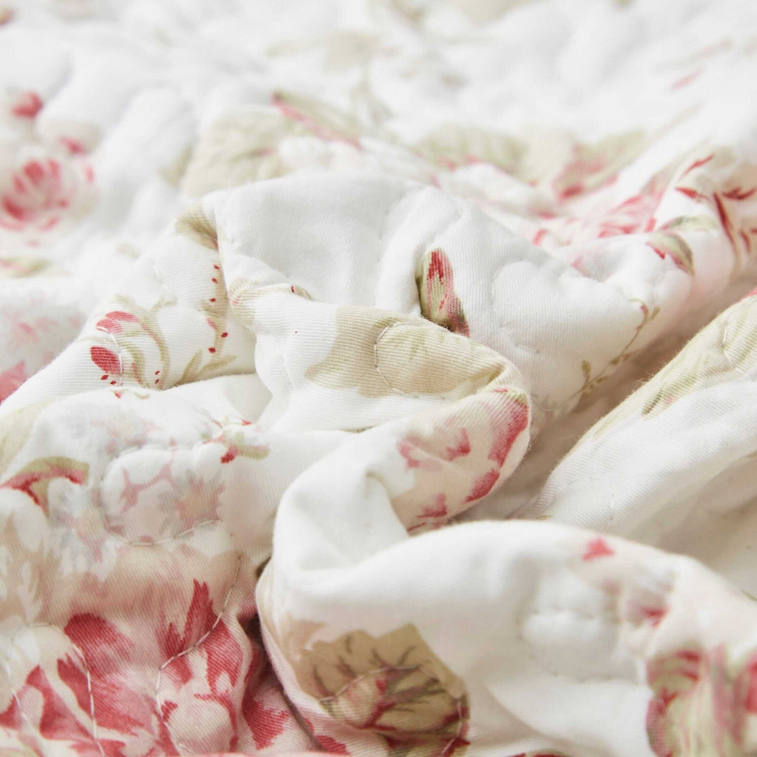 Vintage Cottage Rose Quilted Placemats (Set of 4) featuring pink roses and green leaves on a white background, perfect for farmhouse decor.