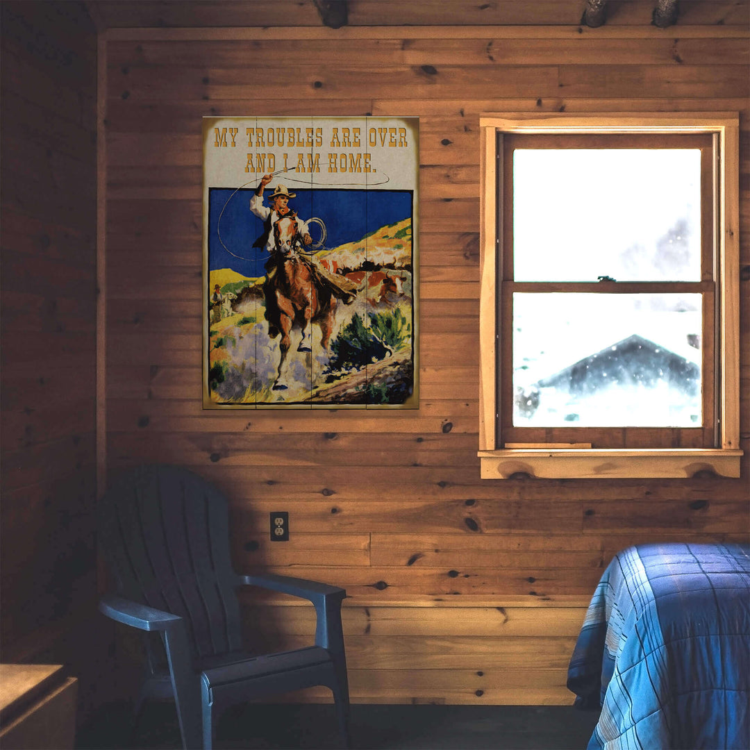 Wooden cabin interior with a poster of a cowboy and text, a window, and a chair.