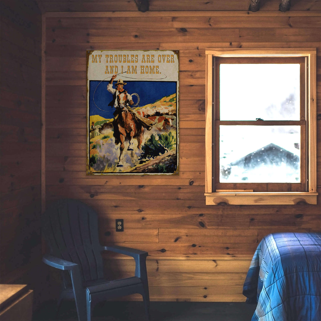 Wooden cabin interior with a poster of a cowboy and text, a window, and a chair.