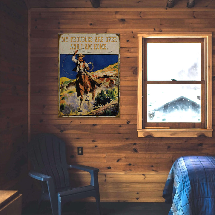Wooden cabin interior with a poster of a cowboy and text, a window, and a chair.