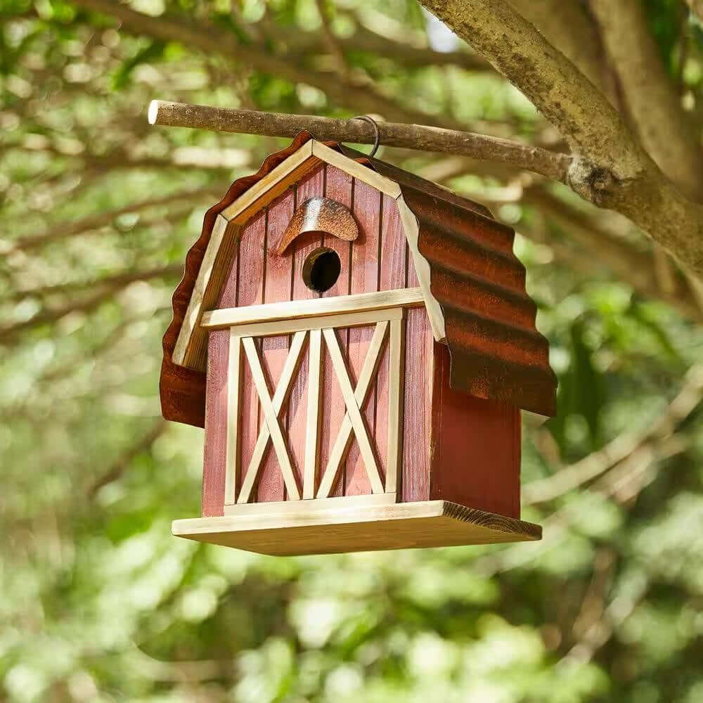Vintage Farmhouse Barn Birdhouse with weathered red finish and metal roof hanging from a tree branch.