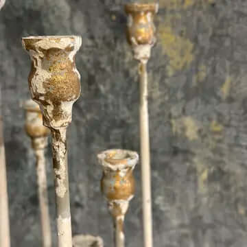 Vintage Farmhouse Candelabra in Distressed White Iron with elegant tall arms and weathered finish, against a rustic background.