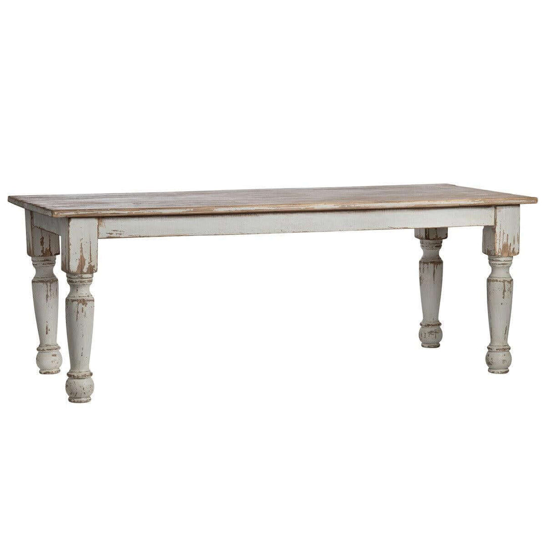 Vintage Farmhouse Harvest Dining Table in Antique White with distressed finish and hand-turned legs, evoking rustic country charm.