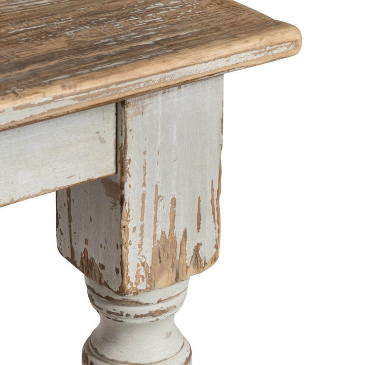 Close-up of Vintage Farmhouse Harvest Dining Table in Antique White showing distressed finish and hand-turned leg detail.